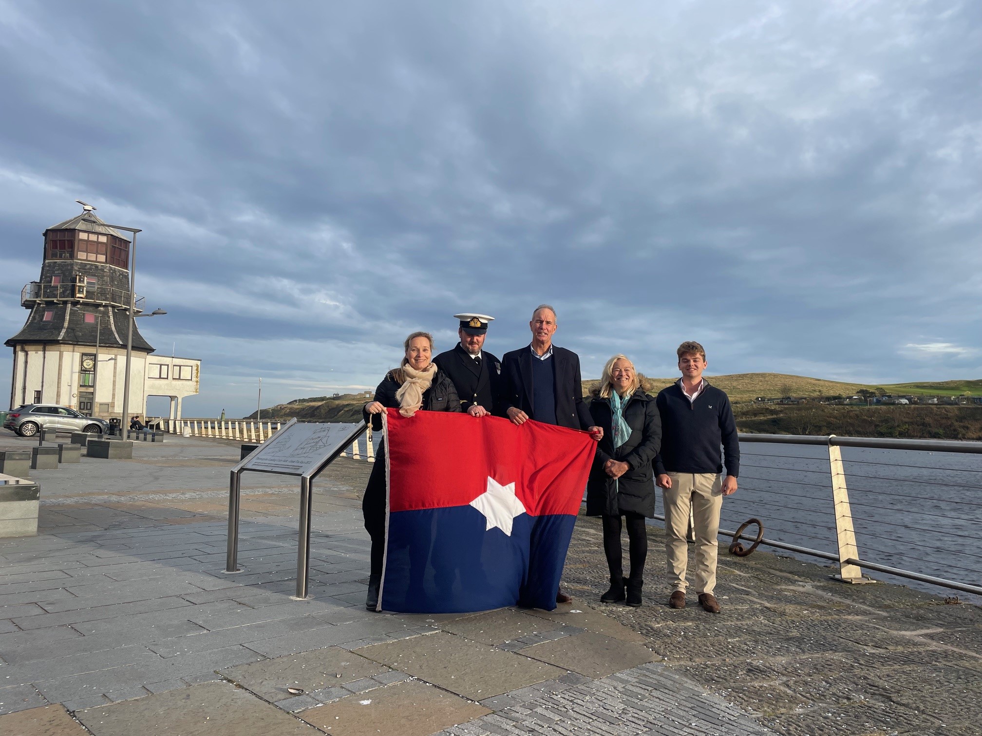 Members of the Aberdeen Line 200 Committee pictured here recently with the Aberdeen Line flag at the plaque on Pocra Quay in Footdee, Aberdeen